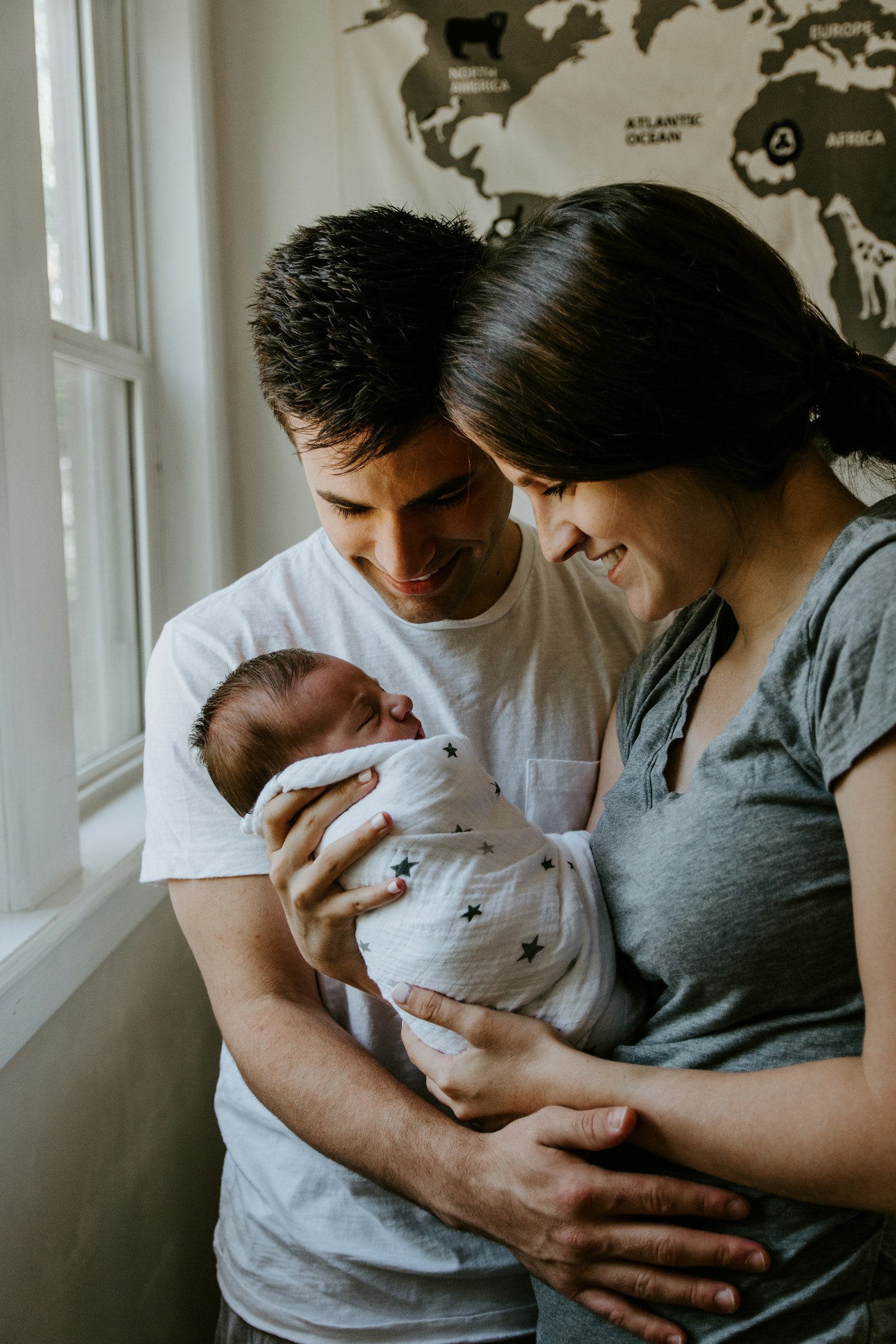 Young family with their baby in a bright, sunlit room
